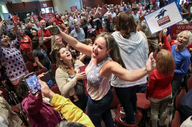 Elicia Brand leads a crowd of angry parents and community members in the singing of the Star Spangled Banner after a Loudoun County School Board meeting was halted by the school board because the crowd refused to quiet down, in Ashburn, Virginia, U.S. June 22, 2021. (Photo by Evelyn Hockstein/Reuters)