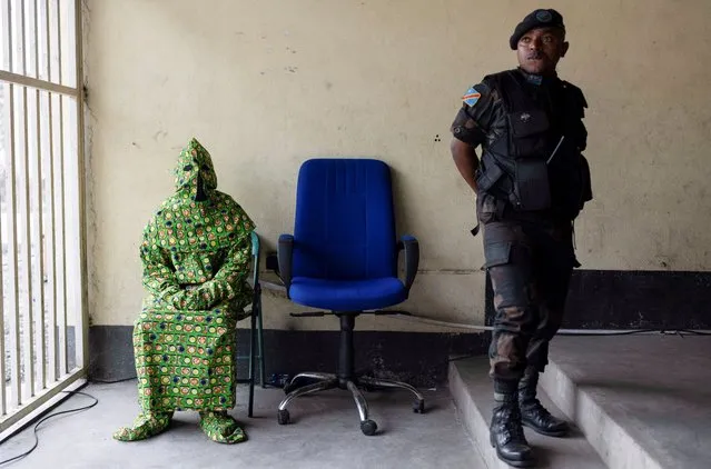 A masked witness rests before testifying in front of the military court at the trial of six soldiers accused of the murder of 56 civilians during a demonstration against the presence of United Nations Organization Stabilization Mission in the Democratic Republic of the Congo (MONUSCO) and East Africa Community Regional Force (EACRF) at the military auditorium in Goma, North Kivu province, Democratic Republic of the Congo on September 15, 2023. (Photo by Arlette Bashizi/Reuters)