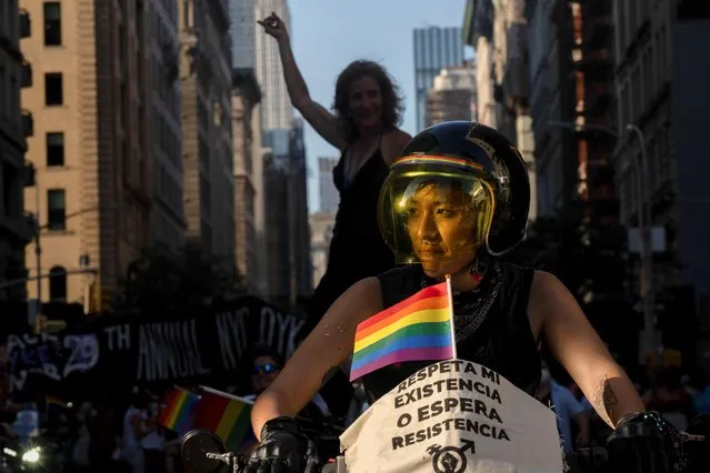 People participate in the “NYC Dyke March” in Manhattan in New York City, New York, U.S., June 26, 2021. The sign reads: “Respect my existence or expect resistance”. (Photo by David Dee Delgado/Reuters)