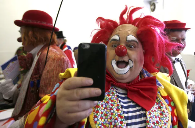 A clown takes a selfie at the All Saints Church hall before the Grimaldi clown service in Dalston, north London, February 7, 2016. (Photo by Peter Nicholls/Reuters)