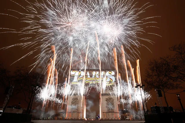 Fireworks are seen at the Arc de Triomphe during New Year's celebrations in Paris, France, January 1, 2019. (Photo by Christian Hartmann/Reuters)