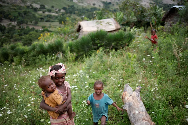 Children play outside a house in Boucan Ferdinand, Haiti, October 5, 2018. (Photo by Andres Martinez Casares/Reuters)