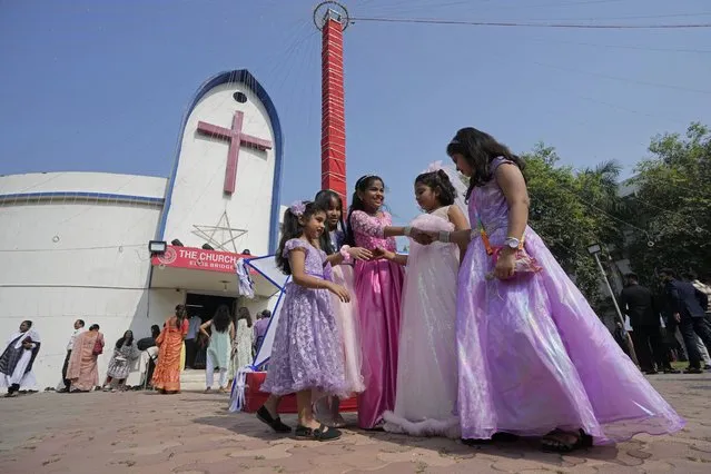 Children greet each other at The Church of North India on Christmas in Ahmedabad, India, Monday, December 25, 2023. (Photo by Ajit Solanki/AP Photo)