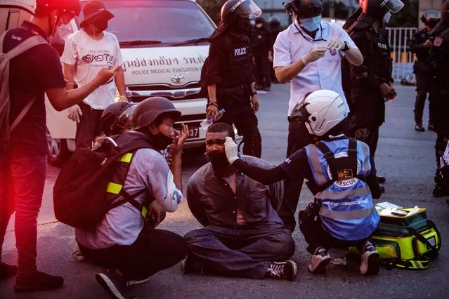 Medics attend to an anti-government protester who was injured on August 22, 2021 in Bangkok, Thailand. Anti-government protesters have continued to hold rallies for weeks, often clashing with police, despite Covid-19 cases remaining at record highs. (Photo by Lauren DeCicca/Getty Images)