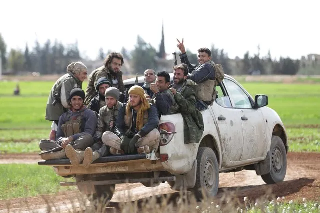 Rebel fighters from “Jaysh al-Sunna” gesture as they ride a vehicle in Tel Mamo village, in the southern countryside of Aleppo, Syria March 6, 2016. (Photo by Khalil Ashawi/Reuters)