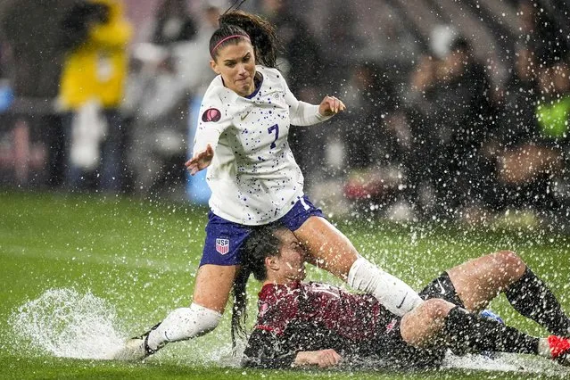 United States' Alex Morgan, above, collides with Canada's Vanessa Gilles during the first half of a CONCACAF Gold Cup women's soccer tournament semifinal match, Wednesday, March 6, 2024, in San Diego. (Photo by Gregory Bull/AP Photo)
