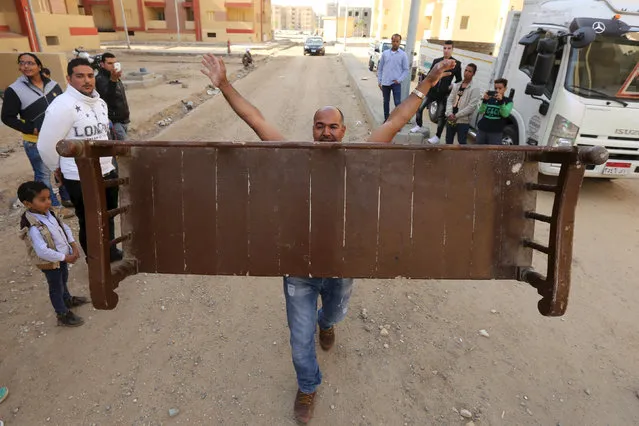 Egyptian strongman Karim Hussein, 38, carries a wooden bench with his mouth in Cairo, Egypt, March 18, 2016. Dubbed “The Pharaoh” by friends and family, Hussein seemed destined to be a strongman from a young age, and claims to have a unique biological makeup that easily absorbs pain. (Photo by Mohamed Abd El Ghany/Reuters)