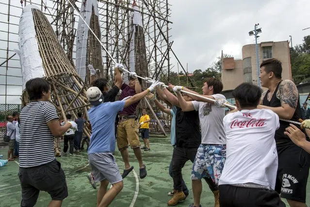 Workers tend to a 13-metre-tall “Bun Mountain”, at Hong Kong's Cheung Chau island, China May 17, 2015, ahead of the upcoming Bun Festival on May 25. (Photo by Tyrone Siu/Reuters)