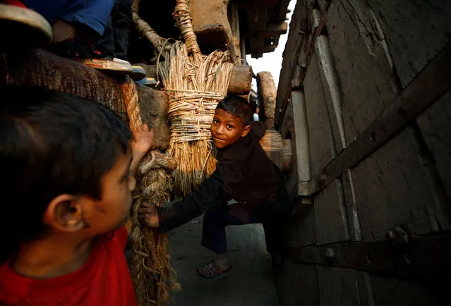 A boy climbs the chariot of God Bhairab during the Bisket festival in Bhaktapur, Nepal, April 13, 2016. (Photo by Navesh Chitrakar/Reuters)