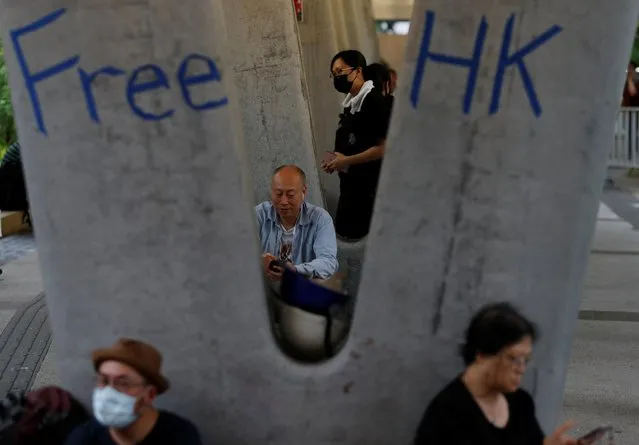 People attend a protest following a day of violence over a proposed extradition bill, under a footbridge leading to the Legislative Council building in Hong Kong, China, June 13, 2019. (Photo by Jorge Silva/Reuters)