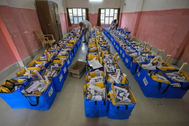 Officials prepare bags of election material to be distributed along with the Electronic Voting Machines (EVMs) ahead of the national parliamentary elections in Jorhat, India, Wednesday, April 17, 2024. (Photo by Anupam Nath/AP Photo)