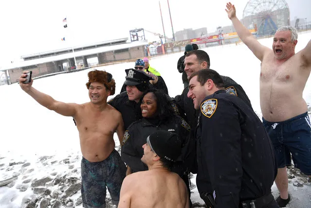 Despite the high winds and fright temperatures, about 1/2 dozen brave members of the Coney Island Polar Bear Club took a dip in the Atlantic Ocean at March 14, 2017, just of Stillwell avenue in Coney Island beach in Brooklyn NYC. Snow began blanketing northeastern United States on Tuesday as a winter storm packing blizzard conditions rolled into the region, prompting public officials to ask people to stay home while airlines grounded flights and schools canceled classes. The National Weather Service issued blizzard warnings for parts of eight states including New York, Pennsylvania, New Jersey and Connecticut, with forecasts calling for up to 2 feet of snow by early Wednesday, with temperatures 15 to 30 degrees below normal for this time of year. (Photo by Paul Martinka)