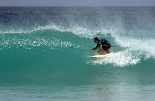 Joao Goncalves, a surfer and hotel owner from the Portuguese town of Peniche, surfs off the coast of Kiritimati Island, part of the Pacific Island nation of Kiribati, April 5, 2016. (Photo by Lincoln Feast/Reuters)