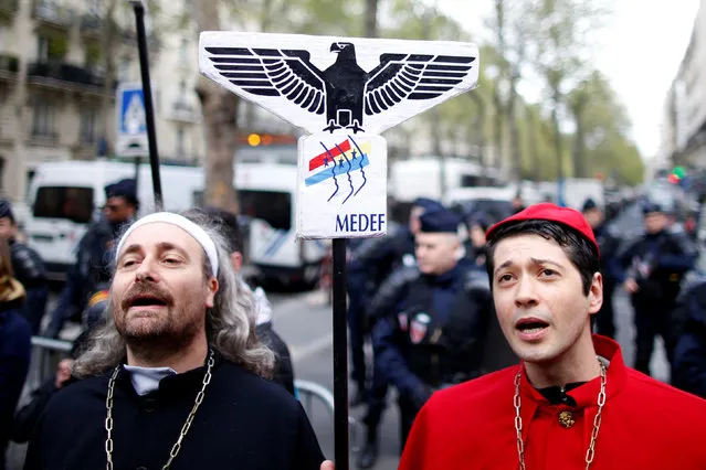 Dressed actors hold a placard with the employer's body MEDEF union logo as they demonstrate in support of temporary arts workers, known as “intermittents” in Paris, France, April 28, 2016 to protest against the change of their unemployment benefits. (Photo by Charles Platiau/Reuters)