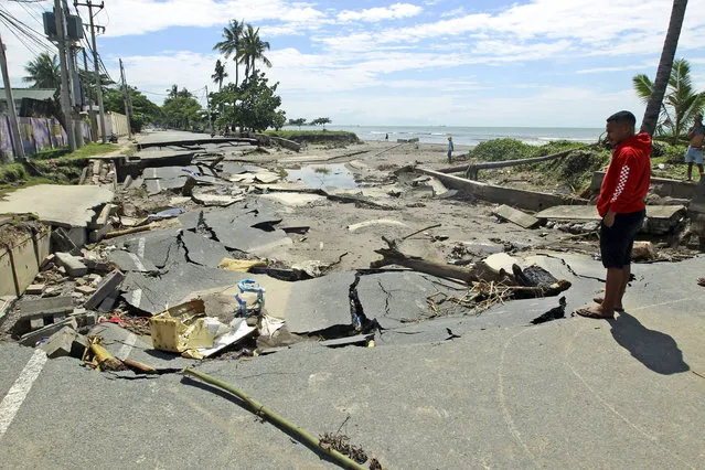 A man inspects a road destroyed after a flood in Dili, East Timor, Tuesday, April 6, 2021. Several disasters brought on by severe weather in eastern Indonesia and neighboring East Timor have left a number of people dead or missing. (Photo by Kandhi Barnez/AP Photo)
