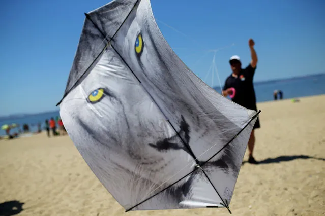 A man flies his kite during an international kite festival in Alcochete, near Lisbon, Portugal, Sunday, June 28, 2015. (Photo by Francisco Seco/AP Photo)