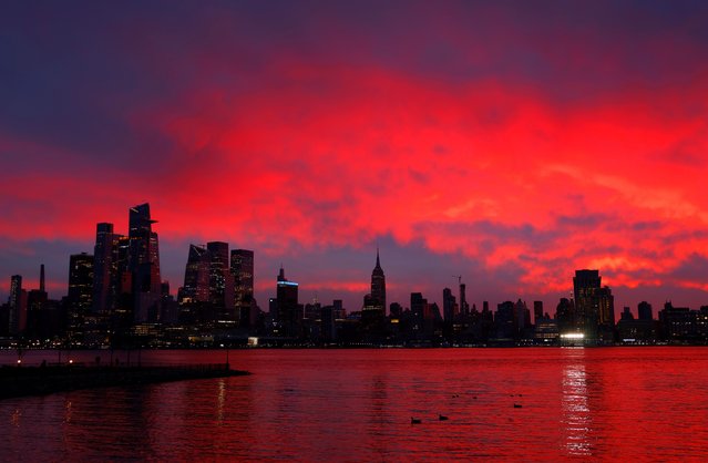 The sun rises behind the skyline of midtown Manhattan and the Empire State Building in New York City on February 9, 2024, as seen from Hoboken, New Jersey. (Photo by Gary Hershorn/Getty Images)