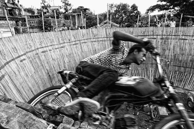 Action Hero. As part of a show called “Well of Death”, a biker performs a stunt at a village fair to celebrate Rath Jatra, a Hindu festival. Dhamrai, Bangladesh. (Photo by Nidal Adnan Kibria/Smithsonian.com)