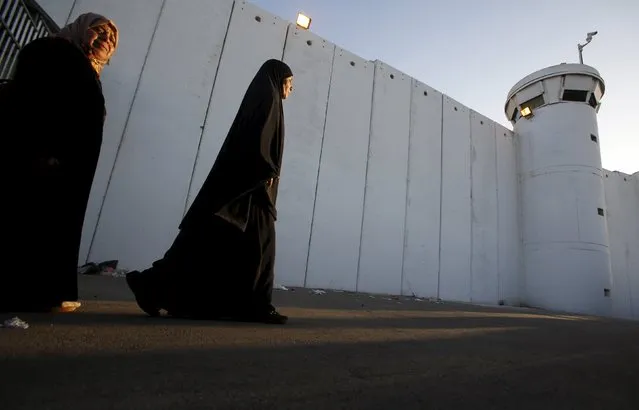 Palestinian women make their way to attend the third Friday prayer of Ramadan in Jerusalem's al-Aqsa mosque, through an Israeli checkpoint in the West bank city of Bethlehem, July 3, 2015. (Photo by Mussa Qawasma/Reuters)