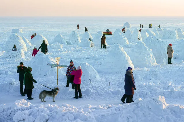 Participants of the Igloo festival “City of the Eskimos” on the ice of the Novosibirsk reservoir near the beach “Boomerang” on February 12, 2022. (Photo by Kommersant Photo Agency/Rex Features/Shutterstock)