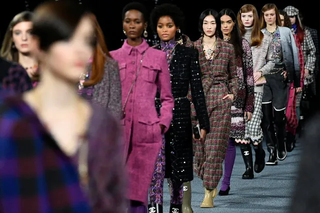 Models present creations by designer Virginie Viard as part of her Fall-Winter 2022/2023 Women's ready-to-wear collection show for fashion house Chanel during Paris Fashion Week in Paris, France, March 8, 2022. (Photo by Piroscka van de Wouw/Reuters)