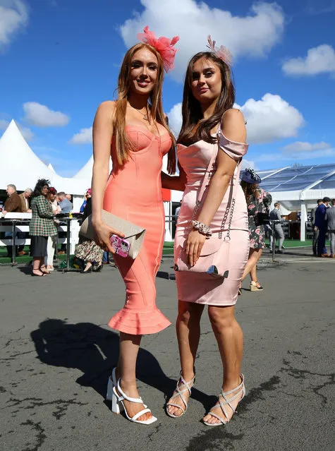 Racegoers pose for photographs at Ladies Day at Aintree Racecourse, Liverpool on Friday, April 8, 2022. (Photo by Nigel French/PA Wire Press Association)