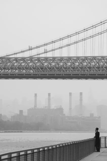 “A View from Williamsburg”. A Hasidic Jewish man looks to Manhattan while waiting for the ferry from Brooklyn. Photo location:  Williamsburg, Brooklyn, New York City. (Photo and caption by Aaron Pierce/National Geographic Photo Contest)