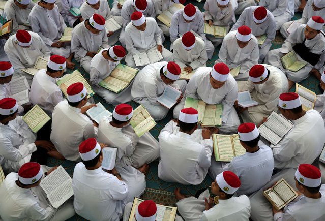 Koranic students of an Islamic boarding school read the Koran on the day of “Nuzul Koran” or “Koran Revelation Day”, on the 17th day of Ramadan when the first verse of the Koran was revealed to Prophet Muhammad, in Kuala Lumpur, Malaysia on March 28, 2024. (Photo by Hasnoor Hussain/Reuters)