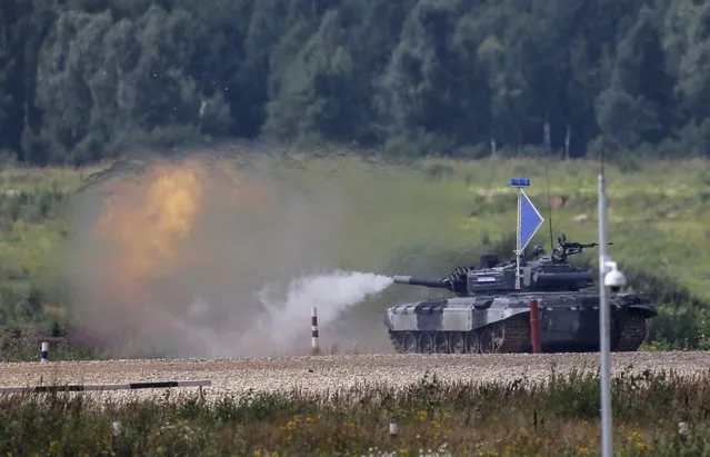 A tank fires at a target on the course of the Tank Biathlon competition during an opening ceremony of the International Army Games-2015 in Alabino, outside Moscow, Russia, August 1, 2015. (Photo by Maxim Shemetov/Reuters)