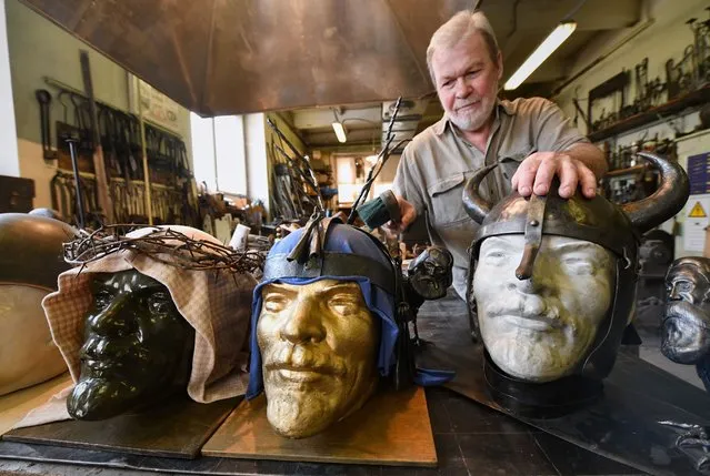 Sergey Kolchin, assistant professor at the Siberian Federal University School of Non-Ferrous Metals and Materials Science works on an iron helmet for a Lenin bust in Krasnoyarsk, Russia on April 28, 2022. (Photo by Alexander Manzyuk/Anadolu Agency via Getty Images)