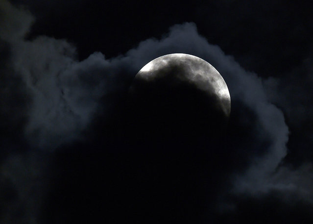 Clouds pass in front of the supermoon early on Saturday, July 12, 2014, in Olathe, Kansas. (Photo by John Sleezer/Kansas City Star/MCT)