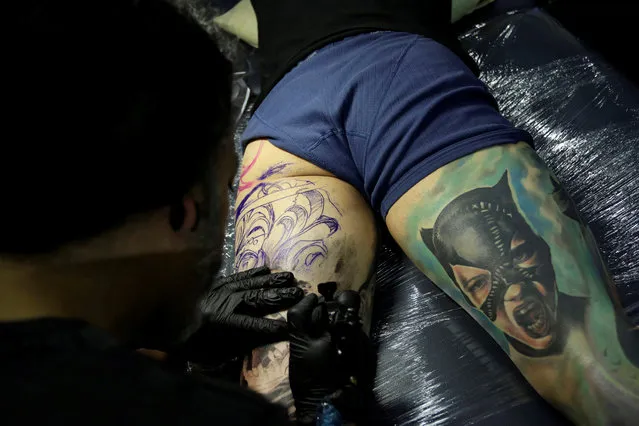 A tattoo artist works on a man's leg during the “Expo Tatuaje” international tattoo expo in Monterrey, Mexico, July 1, 2017. (Photo by Daniel Becerril/Reuters)