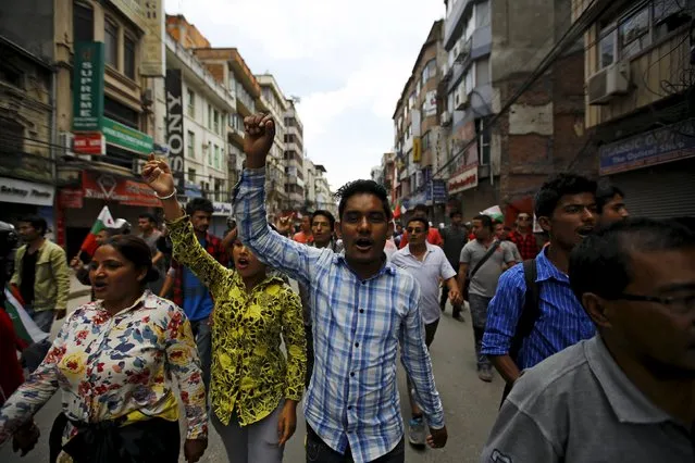 Protesters chant slogans as they march on a road during a general strike organised by a 30-party alliance led by a hardline faction of former Maoist rebels, who are protesting against the draft of the new constitution, in Kathmandu, Nepal August 16, 2015. (Photo by Navesh Chitrakar/Reuters)