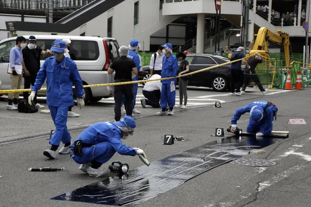 Police officers at the scene where Former Japanese Prime Minister Shinzo Abe was shot during a political event in Nara, Japan, on Friday, July 8, 2022. Abe was unresponsive after being shot during a political event on Friday, shocking a nation where gun violence is rare. (Photo by Kosuke Okahara/Bloomberg)