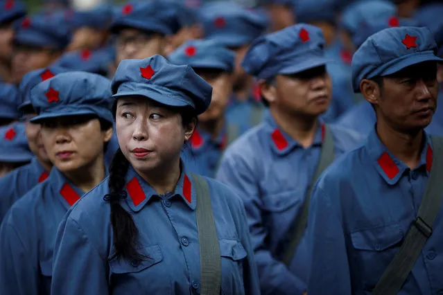 Participants dressed in replica red army uniforms stand in formation during a Communist team-building course extolling the spirit of the Long March, organised by the Revolutionary Tradition College, in the mountains outside Jinggangshan, Jiangxi province, China, September 14, 2017. (Photo by Thomas Peter/Reuters)