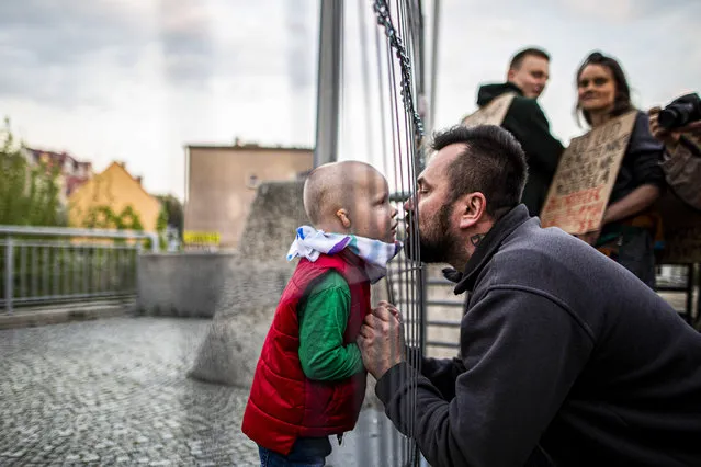 A father and his son get together at the border during a demonstration against the closed german-polish border on April 24, 2020 in Goerlitz, Germany. Poland and Czech Republic decided to close the border at midnight between 14th and 15th of March to Germany trying to stop spreading of Corona virus. Background of these protests is the restriction for polish people, who have to commute everyday to Germany because of their work or school. If they cross the border to Poland again they have to be quarantined. Thats why many polish workers lost their job or had to stay in Germany separated from their families. Another reason for the protests are the restrictions for the civil society and their transboundary dedication. (Photo by Florian Gaertner/Photothek via Getty Images)