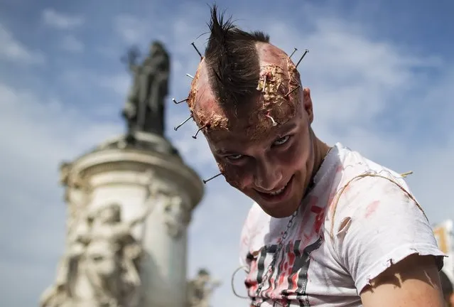 Participants in costume take part in a walk for World Zombie Day 2017, on Place de la Republique in Paris, France, 07 October 2017. More than 50 cities worldwide participate in the worldwide horror festival in which revellers dress up as zombie-related characters. (Photo by Ian Langsdon/EPA/EFE)