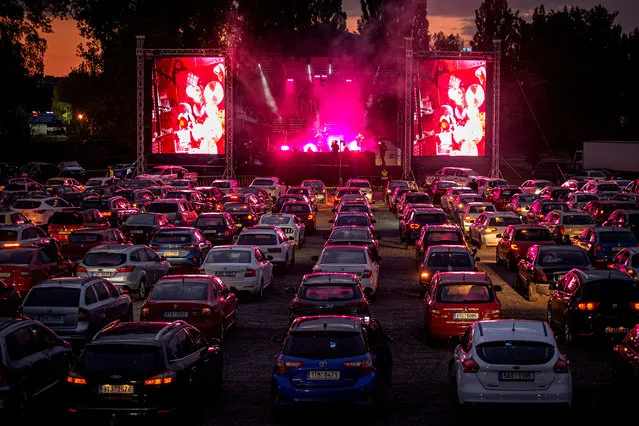 People enjoy the first largest live car concert featuring the band Mirai in Ostrava, Czech Republic on May 15, 2020. The band played their car concert in an industrial environment in the Lower Vitkovice area. The organizers stated that the total capacity of 500 cars was sold out. Viewers were not allowed to leave their vehicles due to government measures to prevent the spread of coronavirus (COVID-19). Only horns, turn signals and lights were allowed to support the band. (Photo by Lukas Kabon/Anadolu Agency via Getty Images)