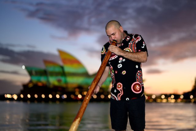 Musician Cameron Leon plays the Didgeridoo at the Dawn Reflection on the Sydney Opera House on Australia Day in Sydney, Australia, 26 January 2025. Australia Day, the official national day of Australia, also known as Invasion Day as it marks the colonization of the country's Aboriginal people, is celebrated every year on 26 January. It commemorates the 1788 landing of the First Fleet and the raising of Great Britain's Union Jack. (Photo by Steven Markham/EPA/EFE)