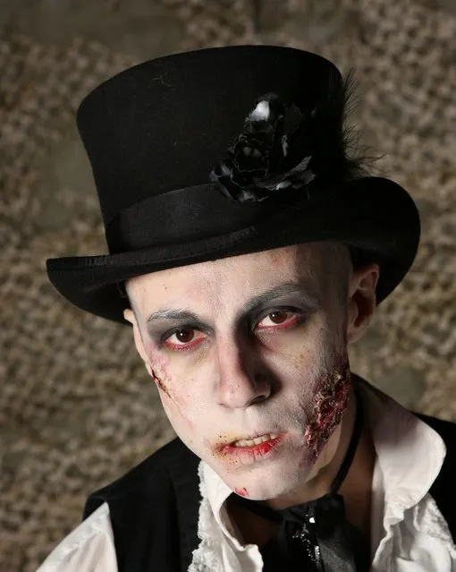 A visitor to the Shocktober Fest dressed as a zombie poses on October 6, 2012 in Turners Hill, England. People dressed as zombies from around the United Kingdom have converged on Tulleys Farm in an attempt to set a new Guinness World Record for the most zombies together in one place.  (Photo by Peter Macdiarmid)