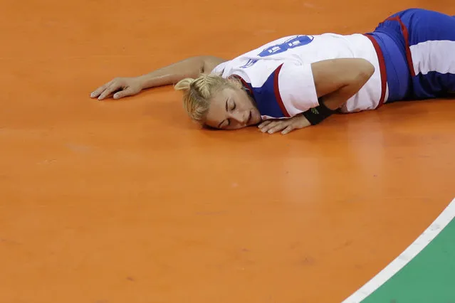 Russia's Anna Sen lies on the ground after scoring during the women's preliminary handball match between the Netherlands and Russia at the 2016 Summer Olympics in Rio de Janeiro, Brazil, Sunday, August 14, 2016. (Photo by Matthias Schrader/AP Photo)