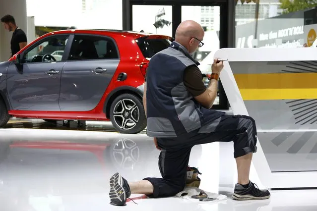 An employee works in front of a Smart forfour car during the media day at the Frankfurt Motor Show (IAA) in Frankfurt, Germany, September 14, 2015. (Photo by Ralph Orlowski/Reuters)