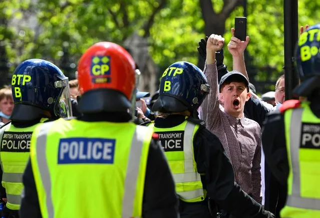 A counter-protester gestures in front of police officers during a Black Lives Matter protest following the death of George Floyd in Minneapolis police custody, at Westminster, in London, Britain, June 13, 2020. (Photo by Dylan Martinez/Reuters)