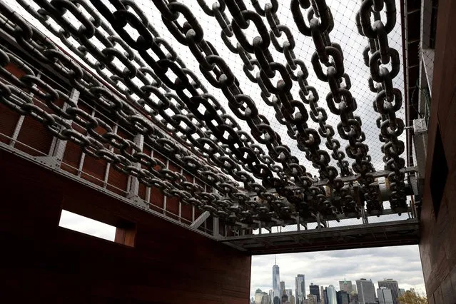 American artist Charles Gaines' second chapter of The American Manifest titled Moving Chains, a 110-foot long kinetic sculpture built from steel and sustainably harvested African Mahogany, is seen on Governors Island in the New York Harbor of New York City, U.S., October 19, 2022. (Photo by Shannon Stapleton/Reuters)