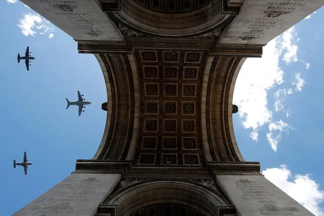 Military aircrafts fly over the Arc de Triomphe during a rehearsal for the Bastille Day celebrations in Paris, France, July 9, 2020. (Photo by Gonzalo Fuentes/Reuters)