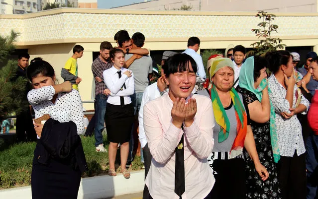 People react as they gather to meet a mourning motorcade and to pay the tribute to the memory of Uzbek late President Islam Karimov in Tashkent, Uzbekistan, September 3, 2016. (Photo by Muhammadsharif Mamatkulov/Reuters)