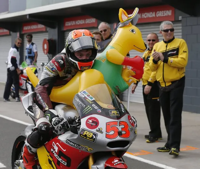 Kalex Moto2 rider Esteve Rabat of Spain rides into the pits with a inflatable kangaroo after placing third in the Australian Moto2 Grand Prix on Phillip Island October 19, 2014. (Photo by Jason Reed/Reuters)