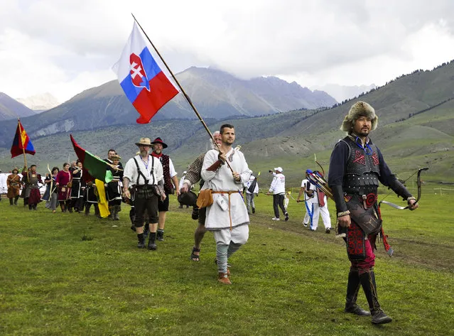 In this photo taken on Sunday, September 4, 2016, Slovakian, right, and Mongolian, left, and participants from other countries attend the second World Nomad Games at Issyk Kul lake in Cholpon-Ata, Kyrgyzstan. (Photo by Vladimir Voronin/AP Photo)