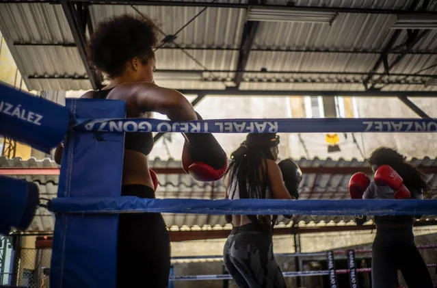 Boxer Giselle Bello Garcia, left, watches as fellow female boxers train in Havana, Cuba, Monday, December 5, 2022. Cuban officials announced on Monday that women boxers would be able to compete for the first time ever. (Photo by Ramon Espinosa/AP Photo)