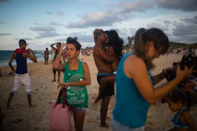 Roydel Cabrales, 35, kisses his girlfriend, Yineti Lozano, 18 at Santa Maria beach, about 15 miles from Havana. It is the closest beach to Havana. The government is demolishing buildings all over the coast of East Havana and recovering and restoring beach dunes. (Photo by Sarah L. Voisin/The Washington Post)